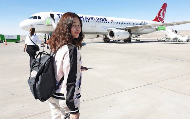 Traveler boarding Turkish Airlines flight for Cappadocia tour from Istanbul.