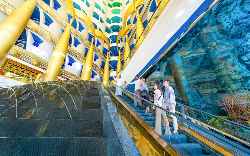 Visitors on an escalator during a guided tour inside Burj Al Arab, Dubai.