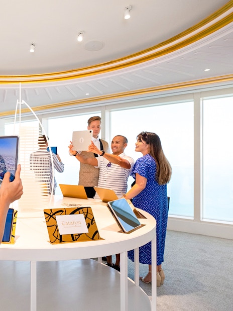 Visitors using tablets during a guided tour inside Burj Al Arab, Dubai.