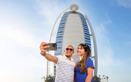 Visitors taking a selfie in front of Burj Al Arab, Dubai.