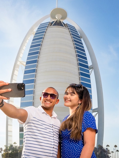 Visitors taking a selfie in front of Burj Al Arab, Dubai.