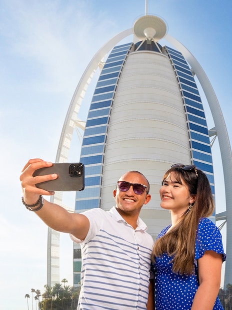 Visitors taking a selfie in front of Burj Al Arab, Dubai.