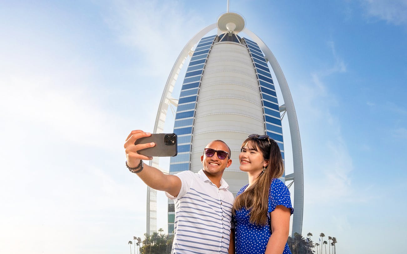 Visitors taking a selfie in front of Burj Al Arab, Dubai.