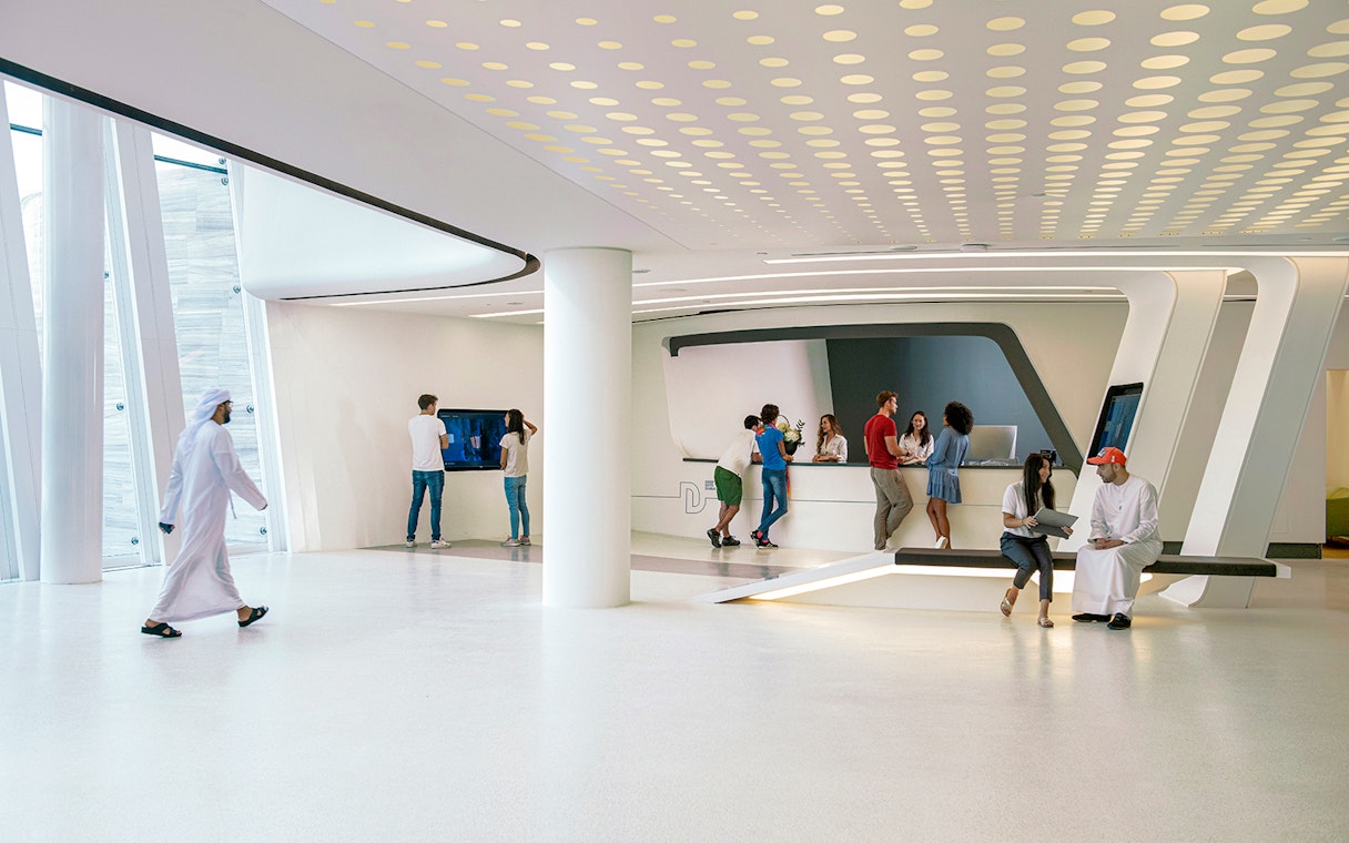 Visitors at Deep Dive Dubai's modern reception area.
