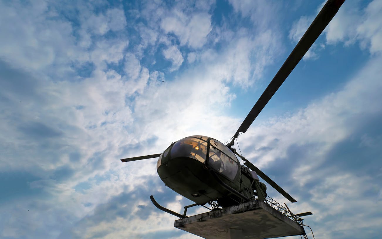 Helicopter display at Erawan National Park, Thailand, under a cloudy sky.