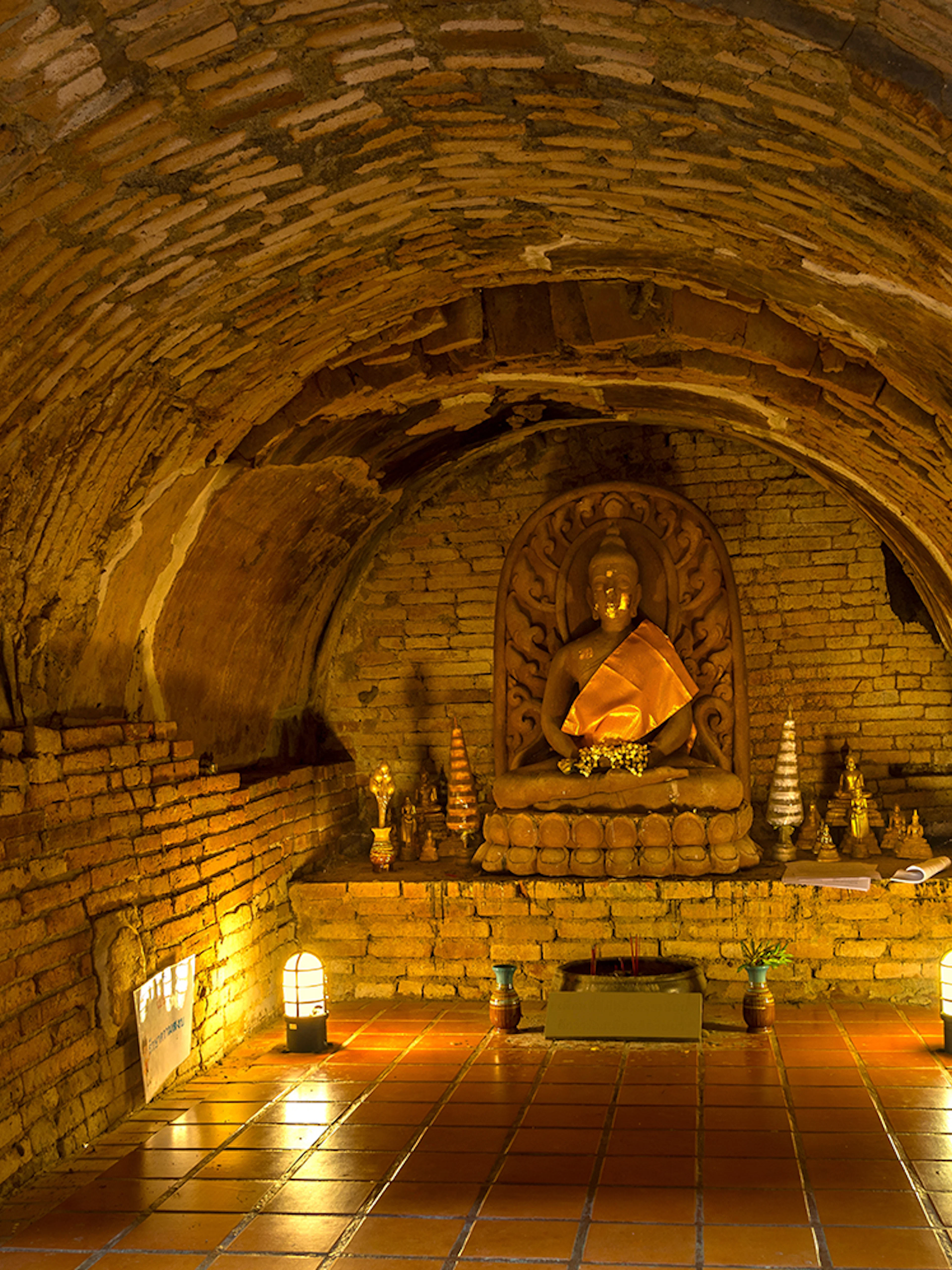 Buddha statue in a brick alcove at Wat Pha Lat, part of the Doi Suthep sunrise tour.