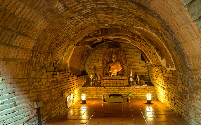 Buddha statue in a brick alcove at Wat Pha Lat, part of the Doi Suthep sunrise tour.