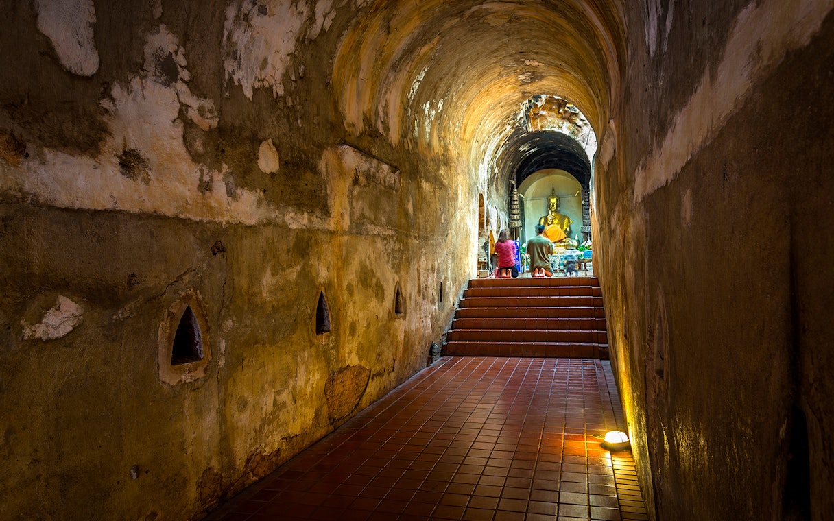 Buddhist shrine inside a tunnel at Wat Pha Lat, part of the Doi Suthep sunrise tour.