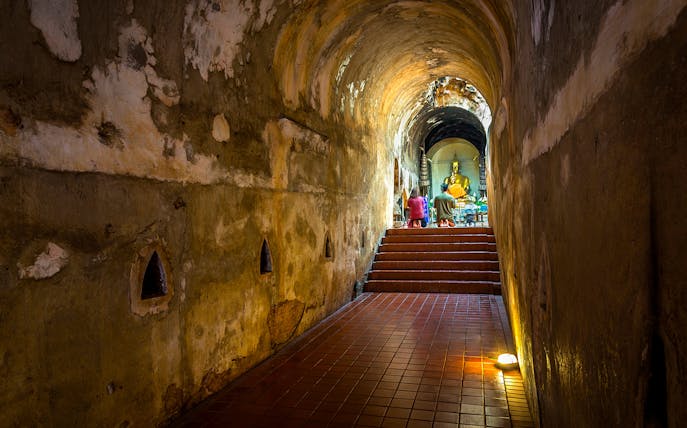 Buddhist shrine inside a tunnel at Wat Pha Lat, part of the Doi Suthep sunrise tour.