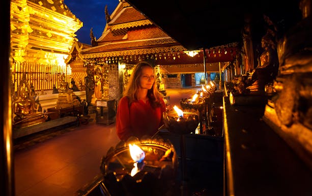 Wat Umong and Doi Suthep temples illuminated at dusk, Chiang Mai evening tour.