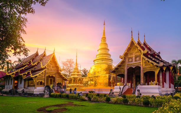Tourists exploring the serene Wat Umong and Doi Suthep Temples during an evening tour in Chiang Mai