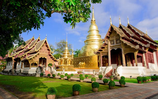 Wat Umong and Doi Suthep temples illuminated at dusk, Chiang Mai evening tour.