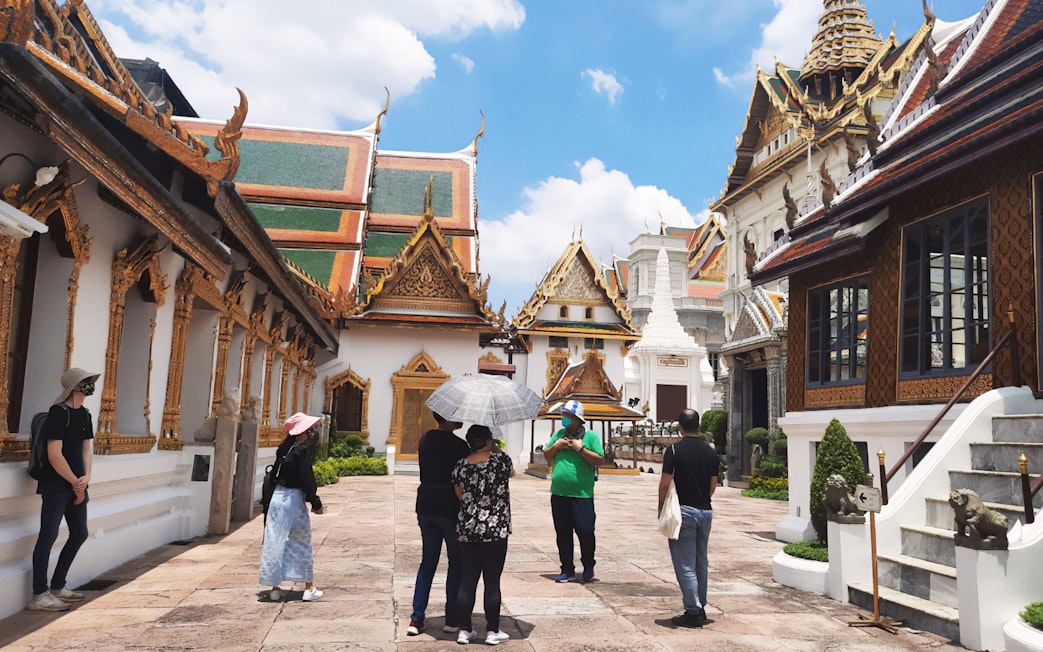 Visitors exploring ornate architecture at Grand Palace, Bangkok during Wat Phra Kaew walking tour.