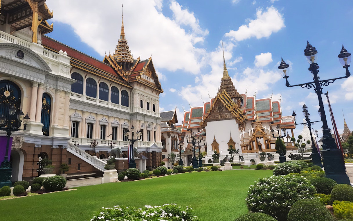 Grand Palace and Wat Phra Kaew buildings with ornate roofs in Bangkok, Thailand.