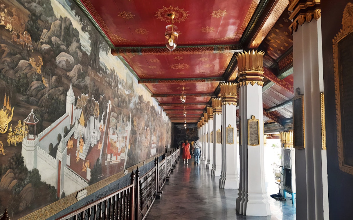 Grand Palace mural corridor with intricate artwork, Bangkok, part of Wat Phra Kaew walking tour.