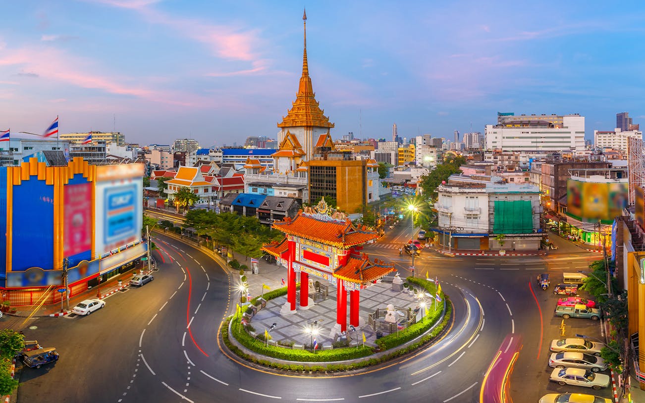 Bangkok Chinatown gate and temple at sunset during walking tour.