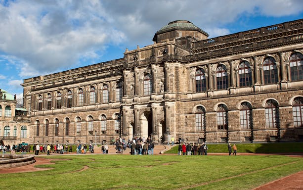 Dresden Zwinger courtyard with visitors, showcasing baroque architecture.