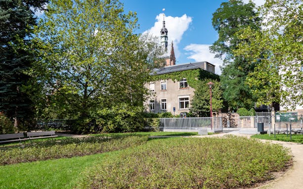 Historic building and lush garden in Dresden, Germany, accessible with Dresden Regional Card.
