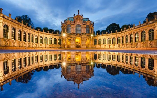Zwinger Palace courtyard at dusk, Dresden, reflected in water.