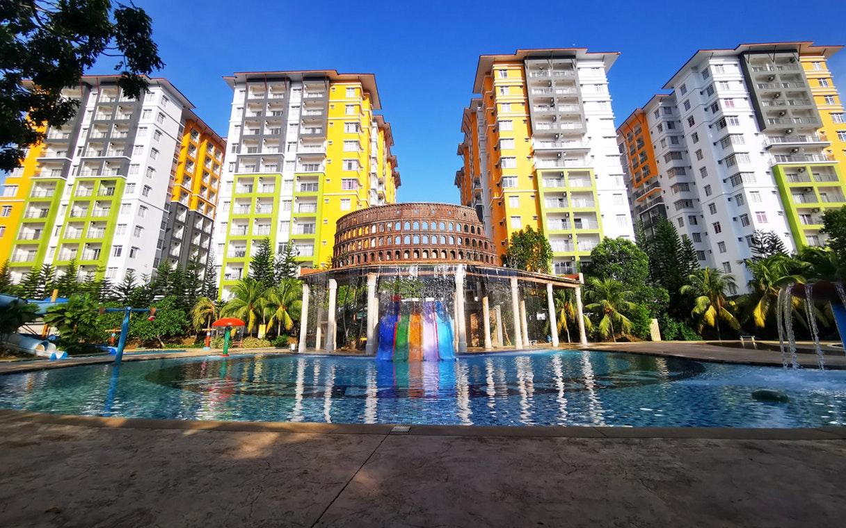 Bayou Lagoon Water Park with colorful slides and tall buildings in the background.