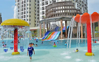 Children playing in the pool with colorful slides at Bayou Lagoon Water Park.