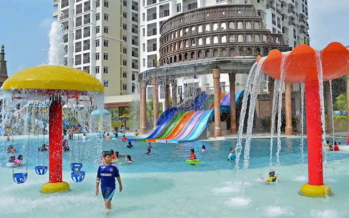 Children playing in the pool with colorful slides at Bayou Lagoon Water Park.