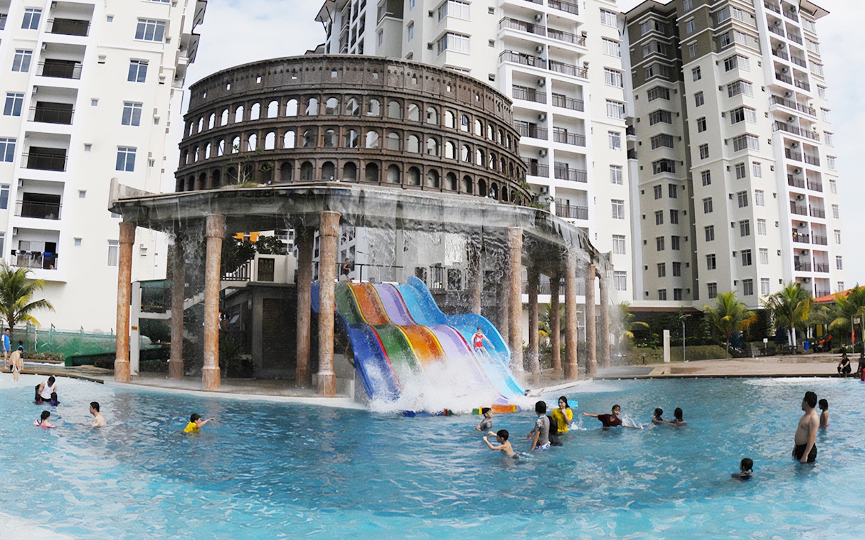 Water slides and pool at Bayou Lagoon Water Park with people enjoying the attractions.