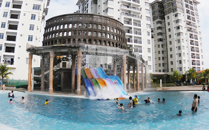 Water slides and pool at Bayou Lagoon Water Park with people enjoying the attractions.