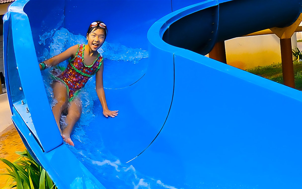 Child enjoying a water slide at Bayou Lagoon Water Park.