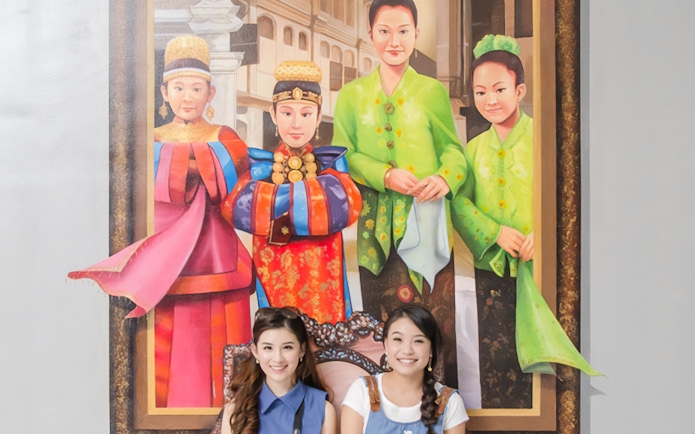 Two visitors pose in front of a 3D mural at Magic Art 3D Museum.