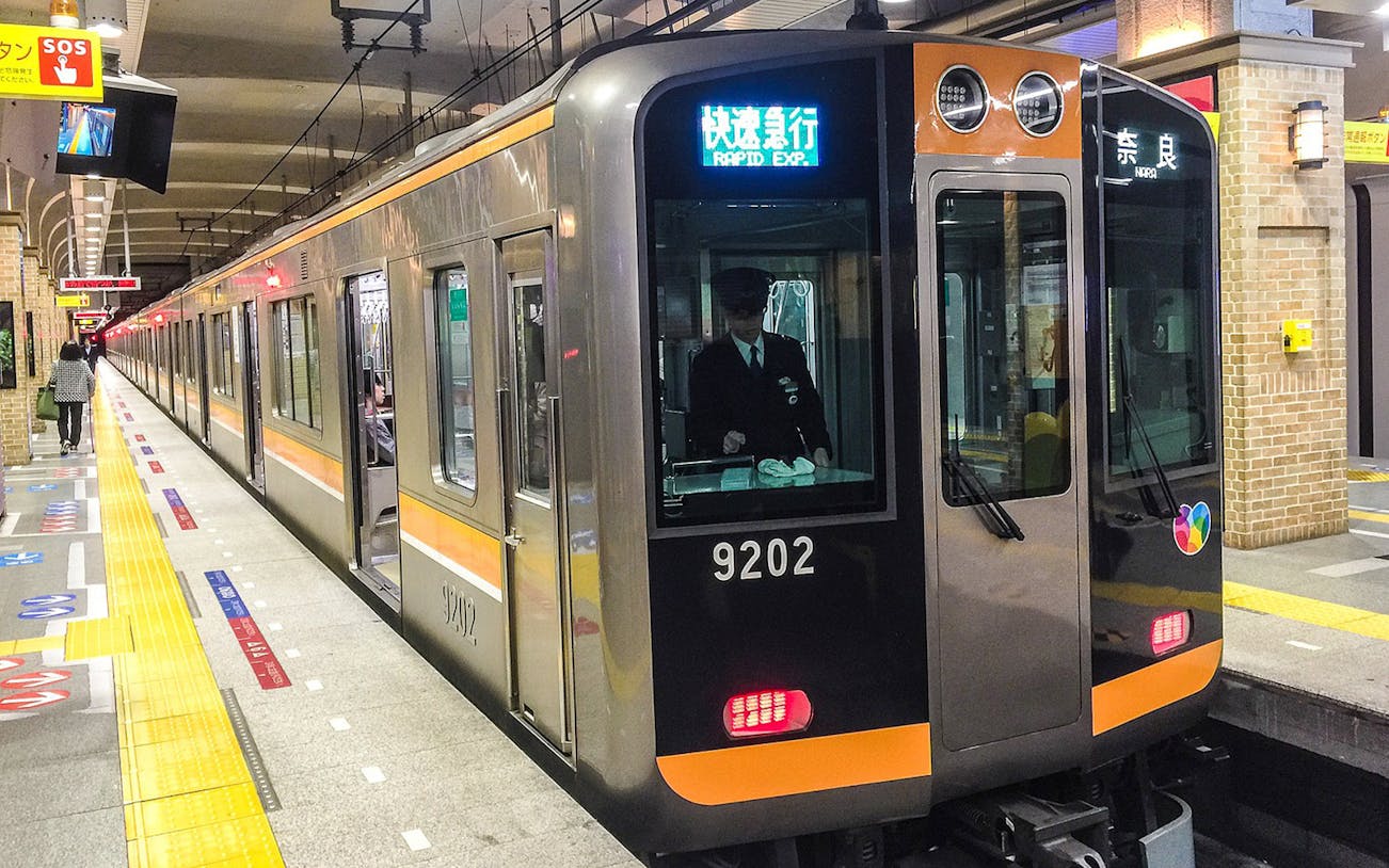 Hanshin train at station platform, Japan, part of 1-day Tourist Pass tour.