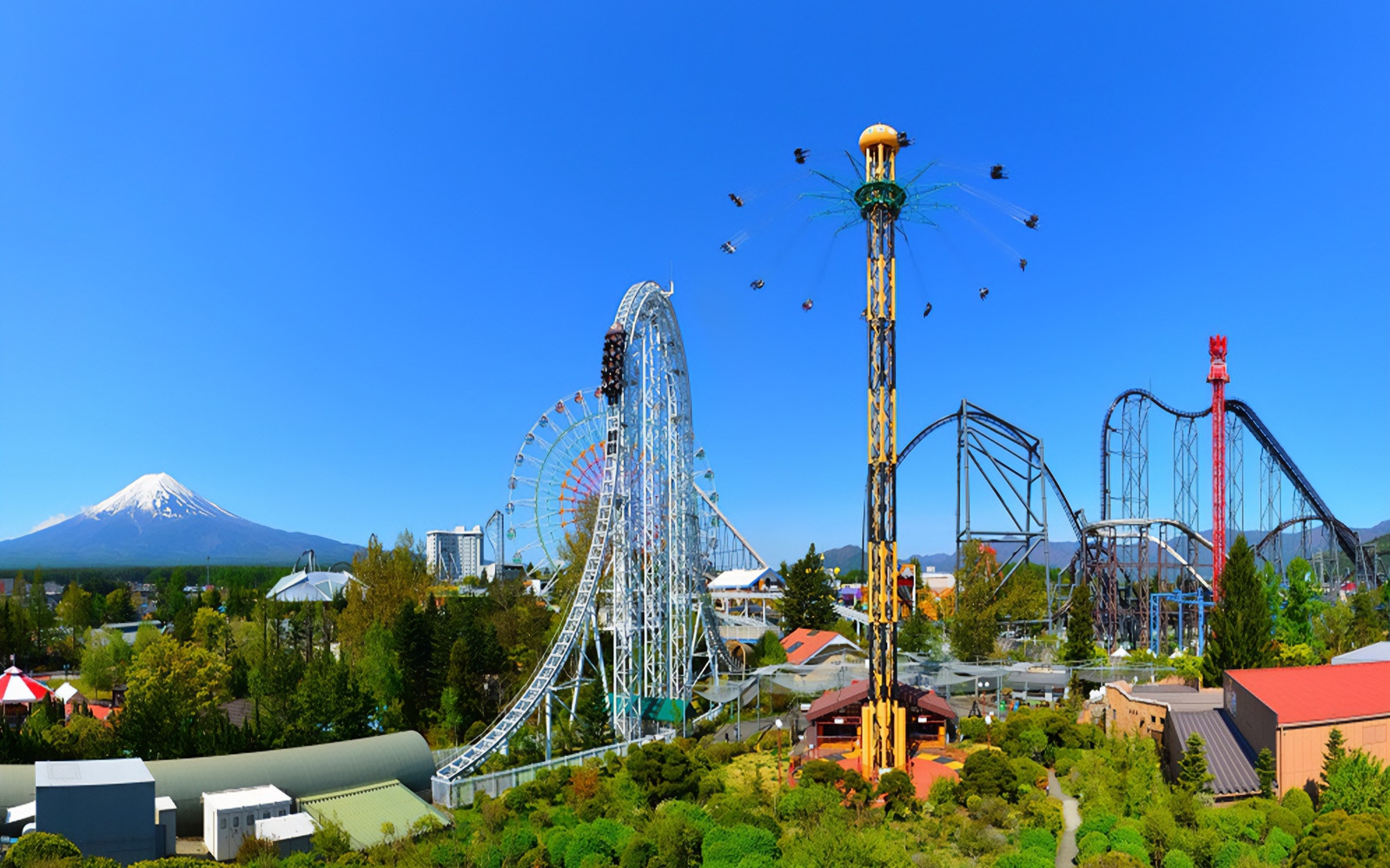Fuji-Q Highland amusement park with roller coasters and Mount Fuji in the background.