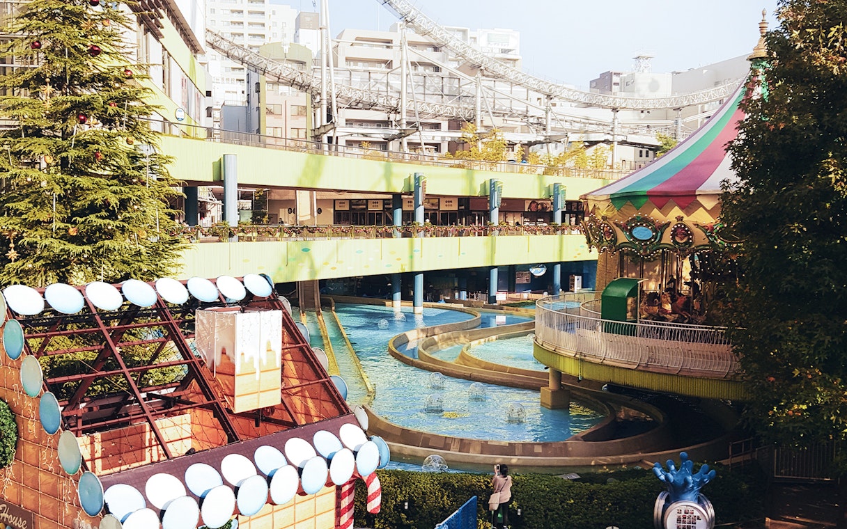 Tokyo Dome City amusement park with carousel and water ride.