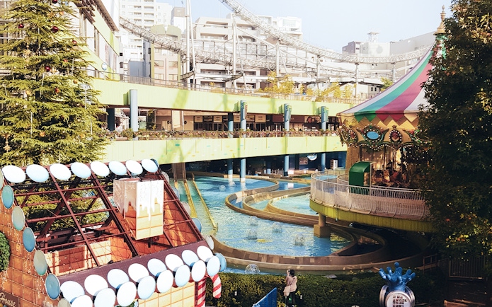 Tokyo Dome City amusement park with carousel and water ride.