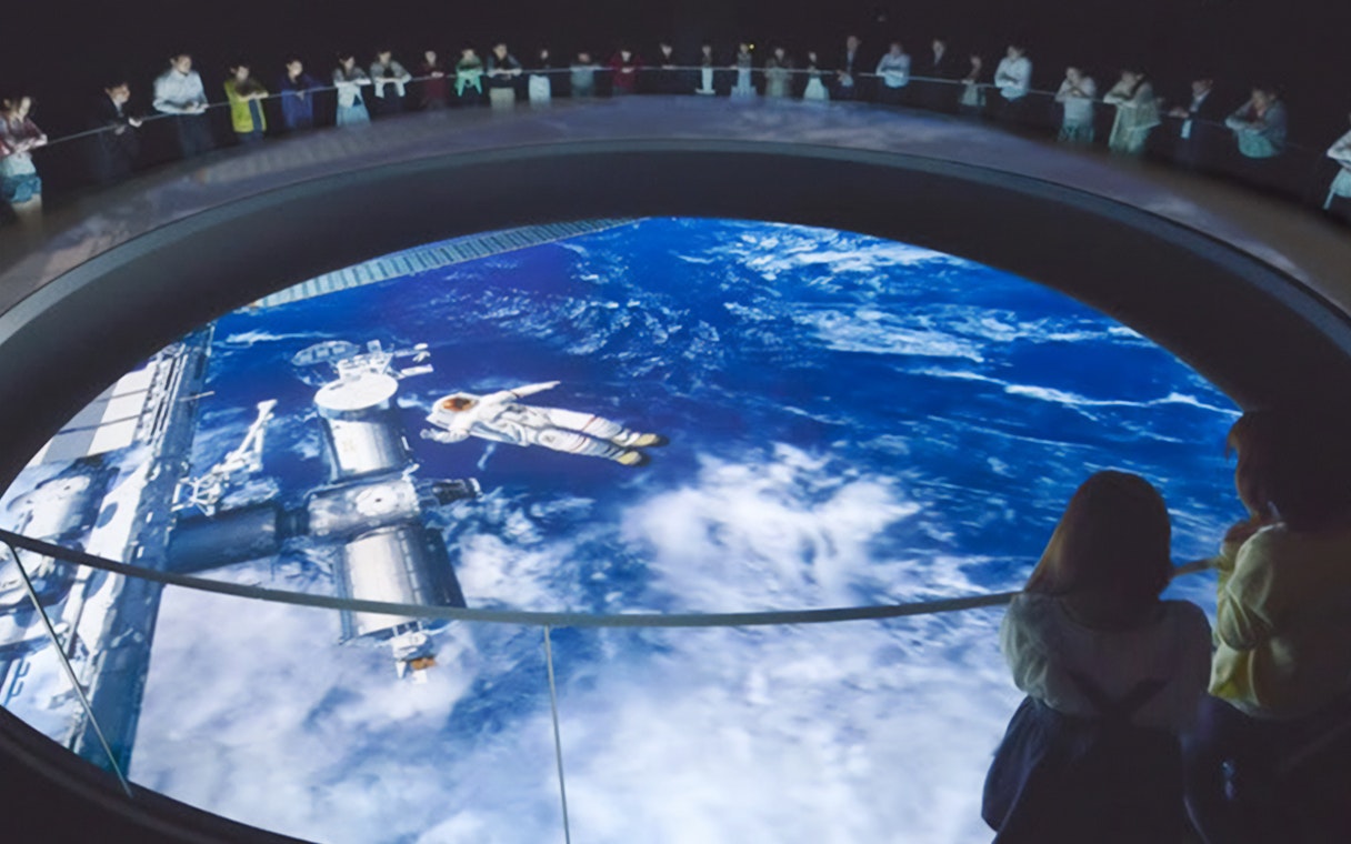 Visitors observing space exhibit at Tokyo Dome City Attractions' Space Museum TeNQ.