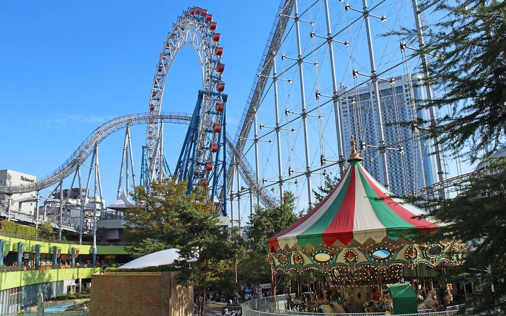 Roller coaster and carousel at Tokyo Dome City Attractions.