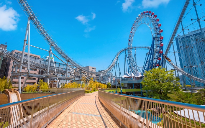 Roller coaster at Tokyo Dome City Attractions with cityscape background.