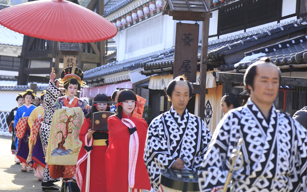 Traditional parade at Edo Wonderland, Japan, featuring participants in historical costumes.