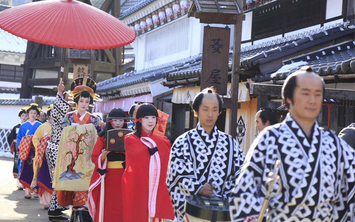 Traditional parade at Edo Wonderland, Japan, featuring participants in historical costumes.