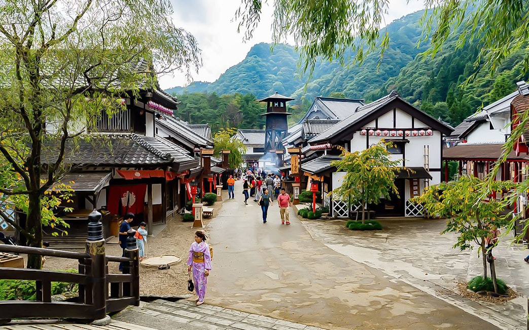 Visitors exploring traditional Edo-period village at Edo Wonderland, Japan.