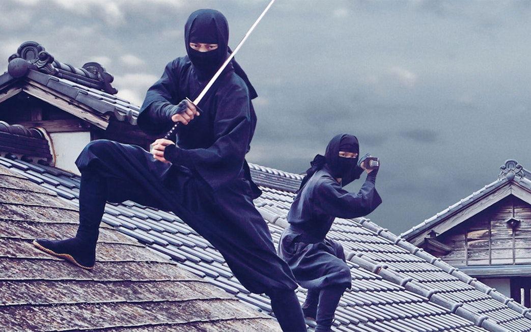 Ninjas on traditional Japanese rooftops at Edo Wonderland.