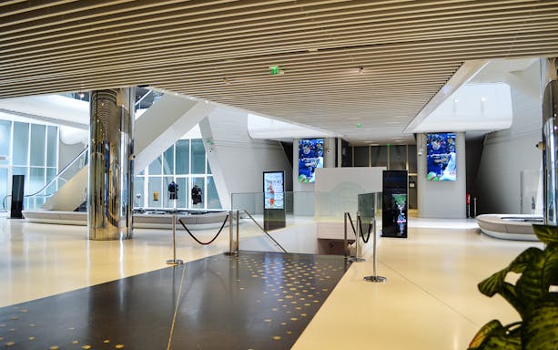 Parc des Princes Stadium interior with displays and escalator, Paris Saint-Germain tour.