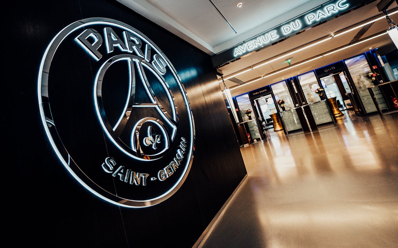 Paris Saint-Germain logo at Parc des Princes Stadium entrance hallway.