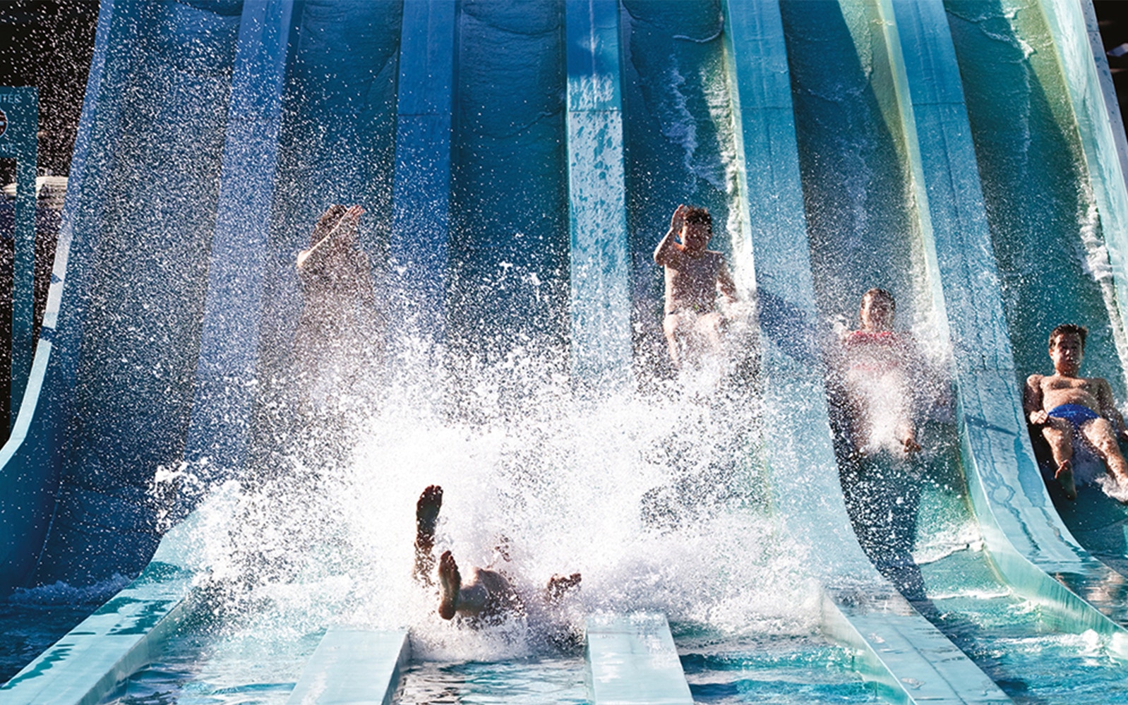 People enjoying water slides at Aquaboulevard, Paris.
