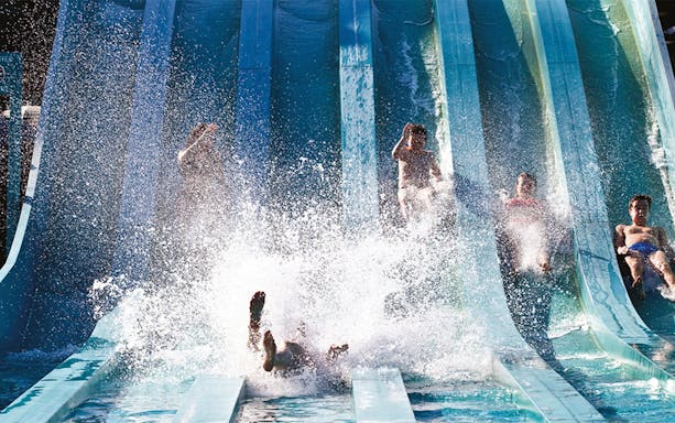 People enjoying water slides at Aquaboulevard, Paris.