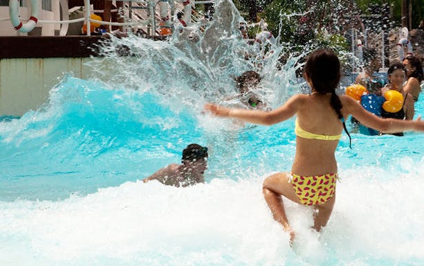 Visitors enjoying wave pool at Aquaboulevard water park.