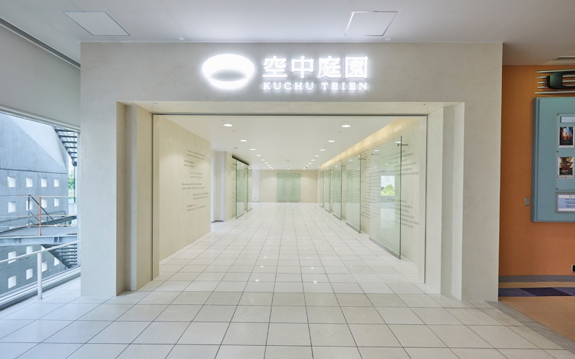 Umeda Sky Building interior hallway with glass walls and tiled floor, Osaka.