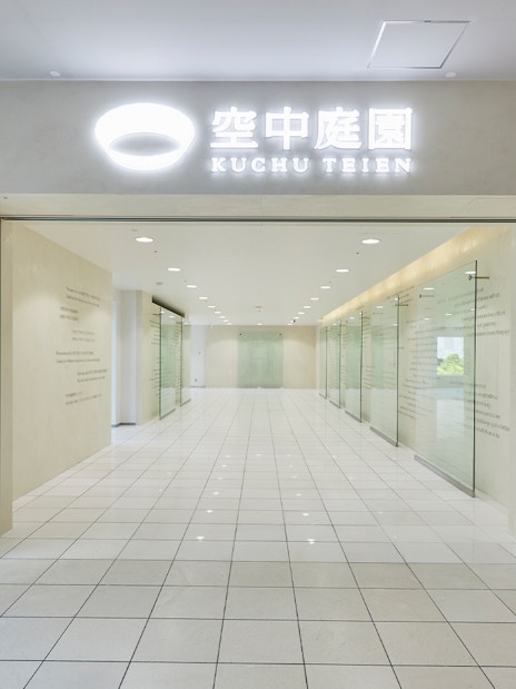 Umeda Sky Building interior hallway with glass walls and tiled floor, Osaka.