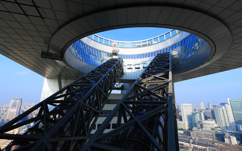 Umeda Sky Building escalators with Osaka cityscape in the background.