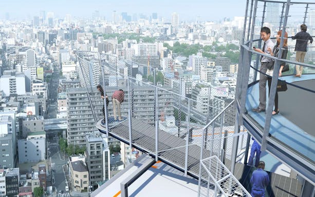 Visitors on Tsutenkaku Tower's observation deck overlooking Osaka cityscape.